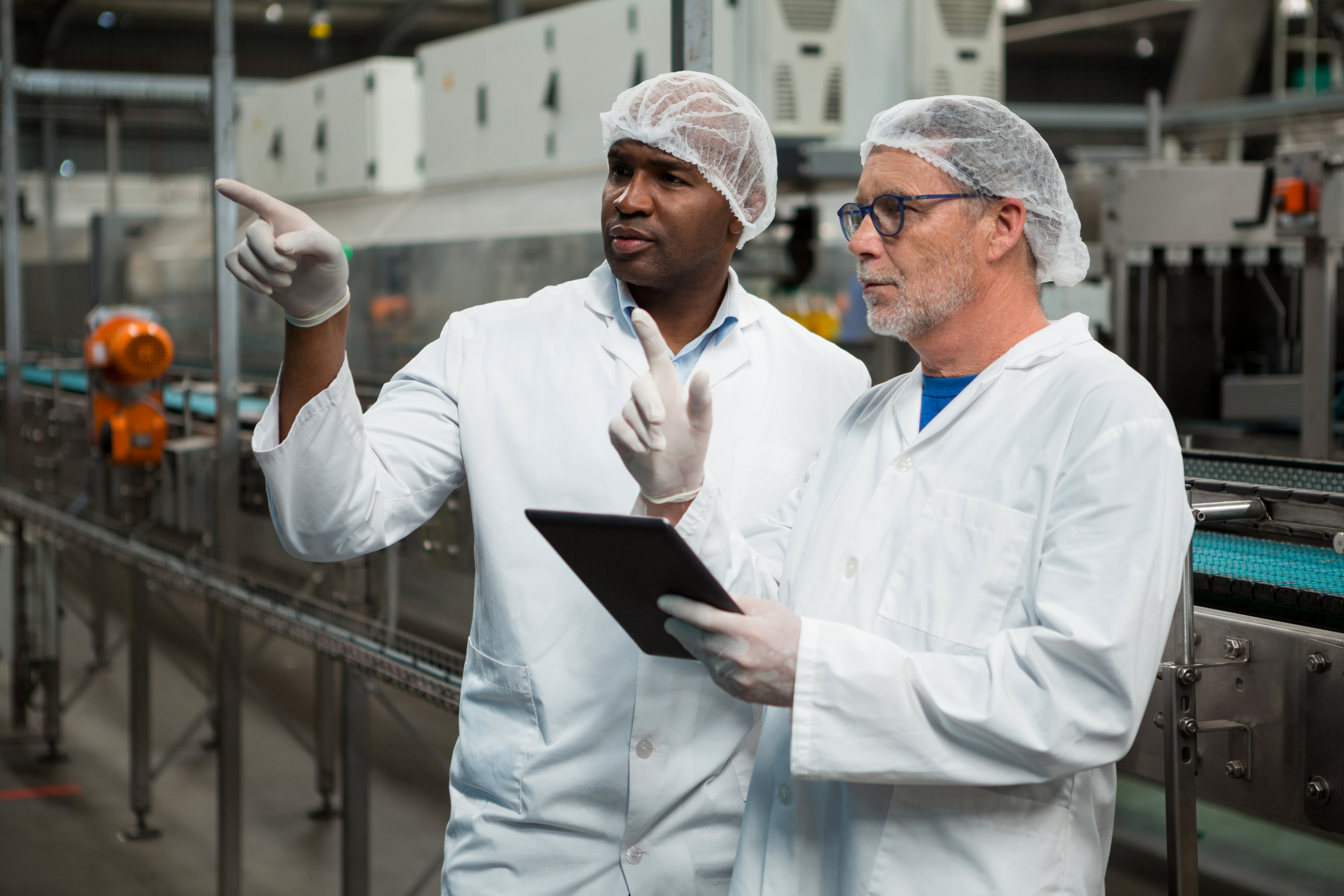 Male workers inspecting products in cold drink factory Male workers inspecting products in cold drink factory